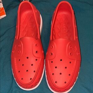 These are Sperry Authentic Original Float boat shoes in redish, orangish color
